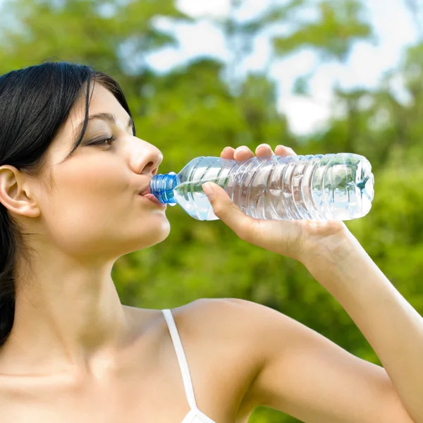 Portrait of woman drinking water outdoor