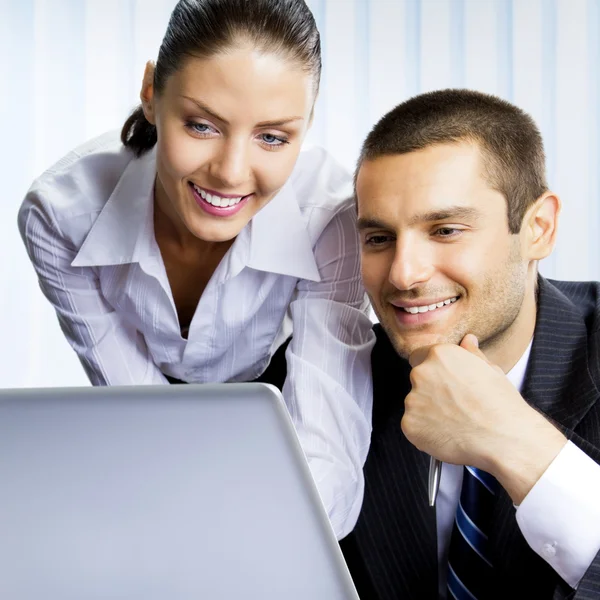 Two business people working with laptop