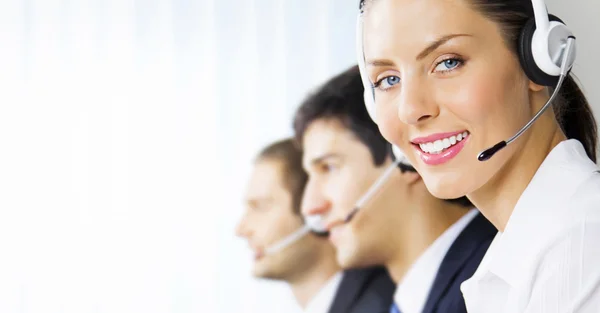 Three support phone operators at workplace