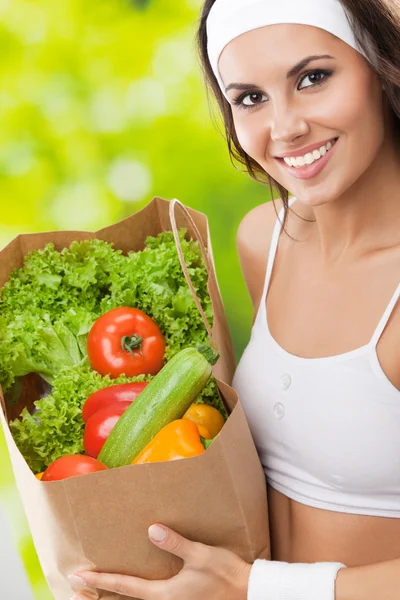 Woman in fitness wear with vegetarian food