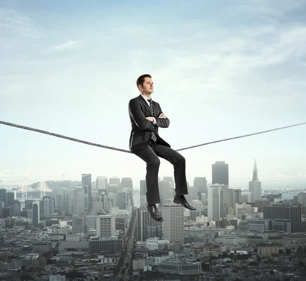 Man sitting on rope