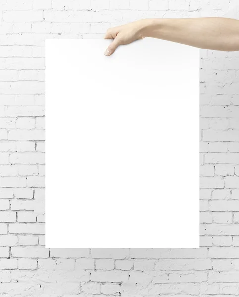 Hand holding blank poster