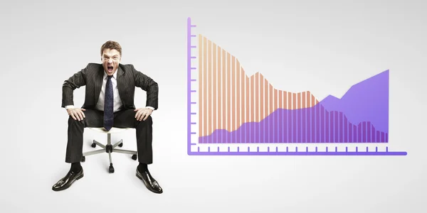 Young business man shouting and sitting on a chair with a graphs