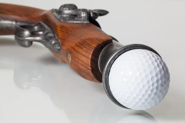 Old gun and golf ball