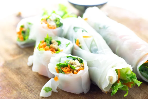 Portion of spring rolls on wood