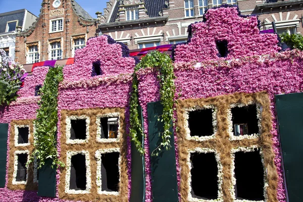HAARLEM, THE NETHERLANDS - APRIL 21 2013: Dutch houses with flowers at flower parade on April 21 2013 in Haarlem, The Netherlands. The annual flower parade is a unique event with one million visitors.