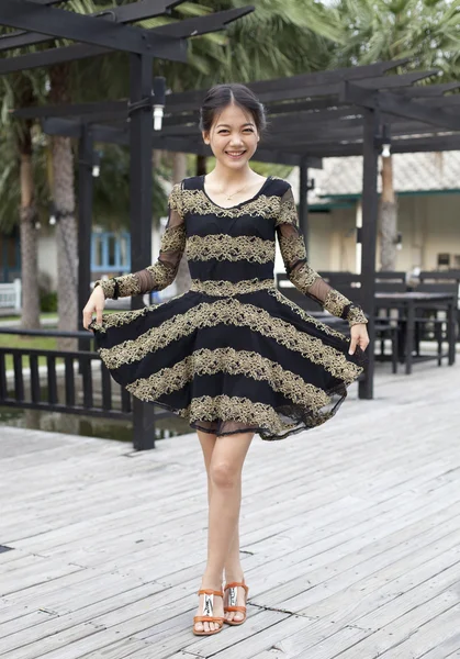 Young woman wearing skirt dress smiling