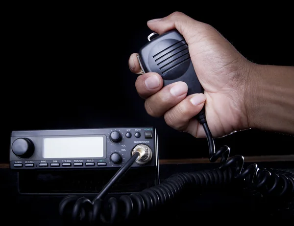 Hand of Amateur radio holding speaker and press