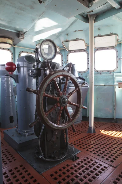 Old wood boat steering wheel in military war ship