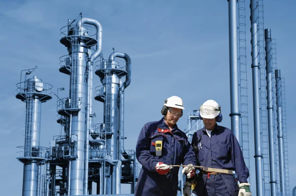 Oil and gas workers in front of oil refinery