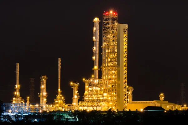 Scenic of petrochemical oil refinery plant shines at night, clos