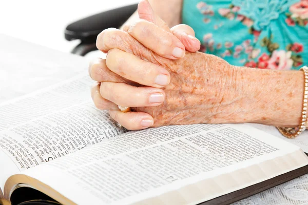 Praying Senior Hands on Bible