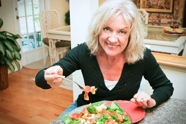 Sexy Senior Woman Eats Healthy