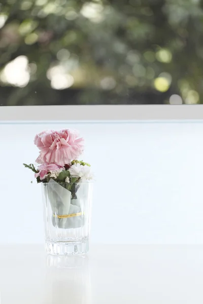 Cute pink flower on table with lighting