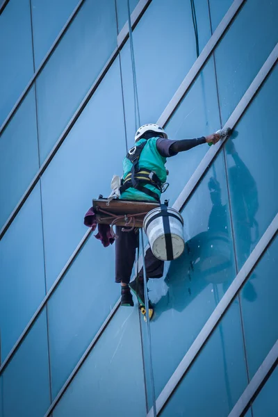 Group of workers cleaning windows service on high rise building