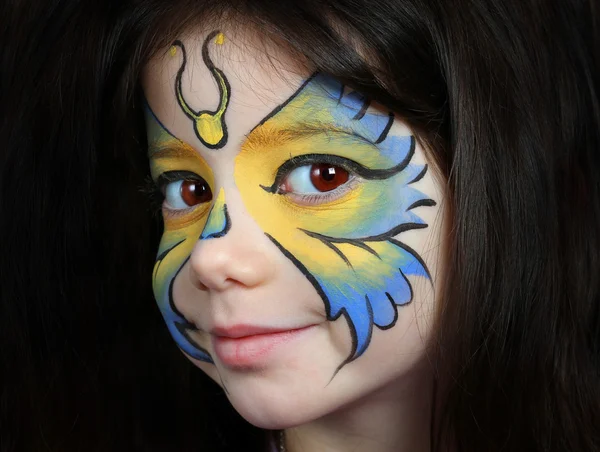 Pretty girl with face painting of a butterfly