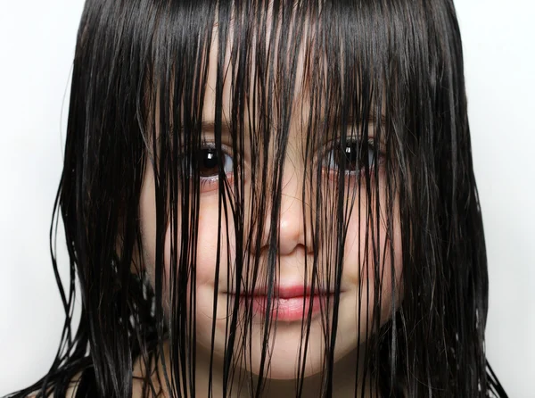 Little girl with wet hair in her face