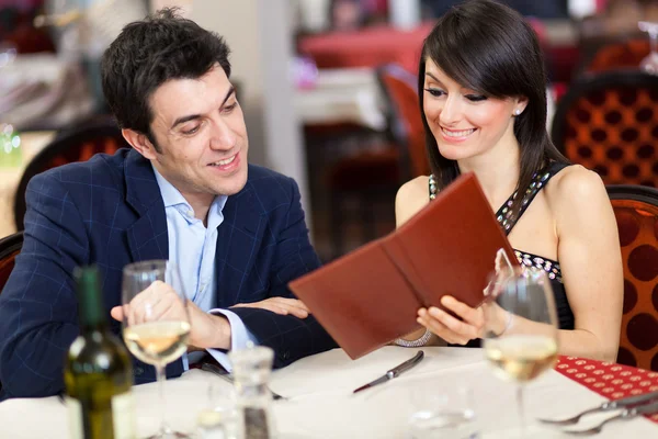 Couple reading the menu in a restaurant