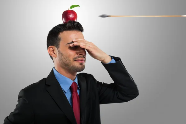 Arrow hitting an apple on a businessman\'s head