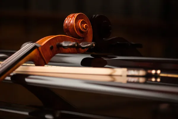 Cello leaning on a piano