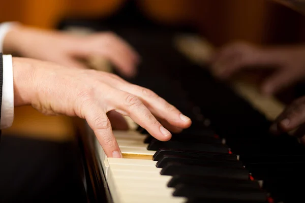 Musician playing a piano keyboard