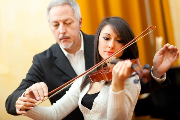 Violin teacher with a student