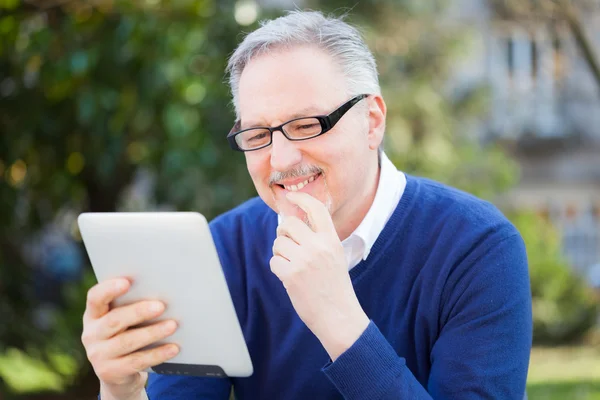 Senior man using a tablet