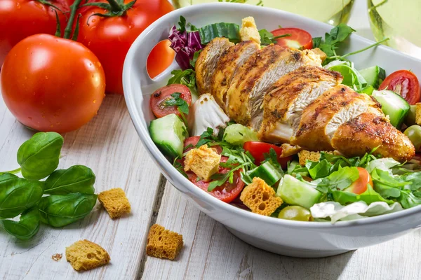 Close-up on a salad with chicken and tomato