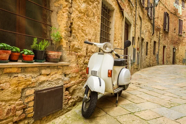 old vespa scooter on the street in italy