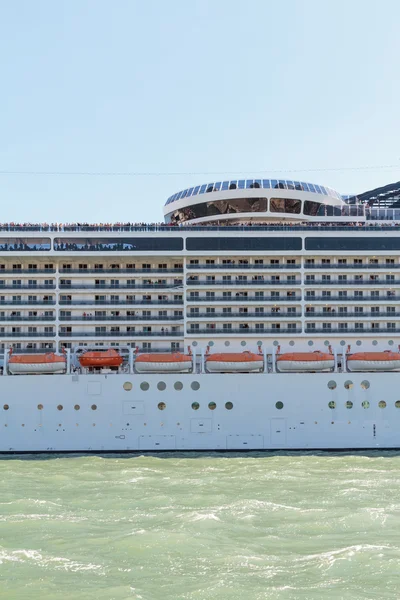 A side of a cruise ship while passing close to Venice