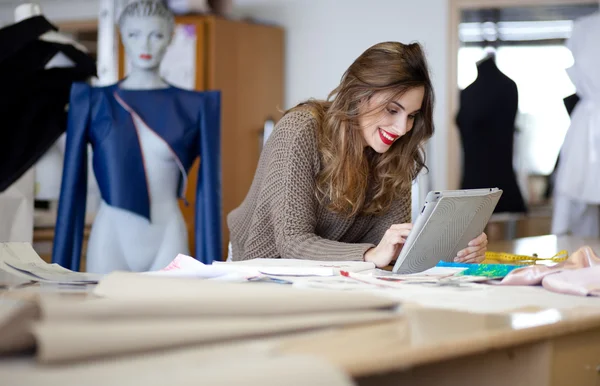 Fashion designer using tablet computer in the studio