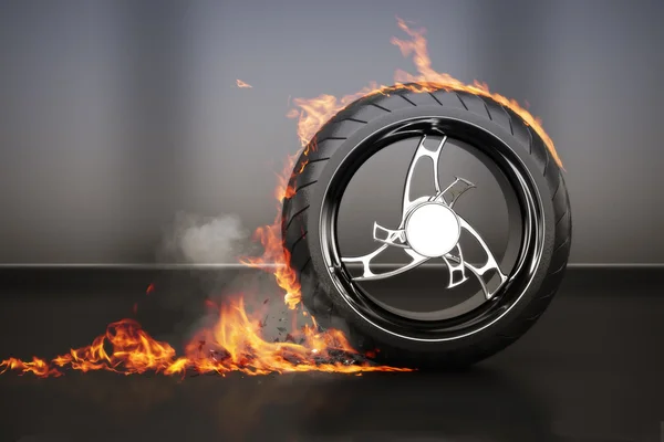 Tire burnout with flames smoke and debris