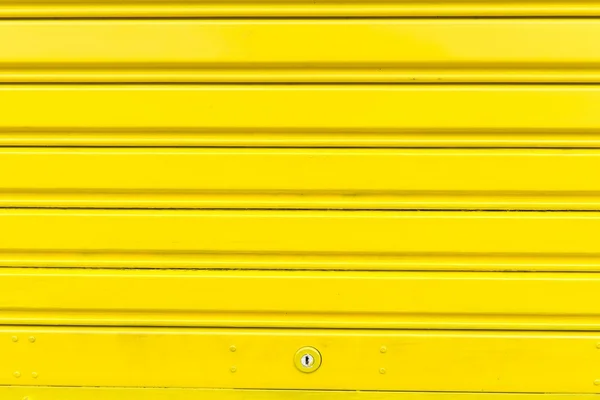 Bright yellow metal sliding door with key hole