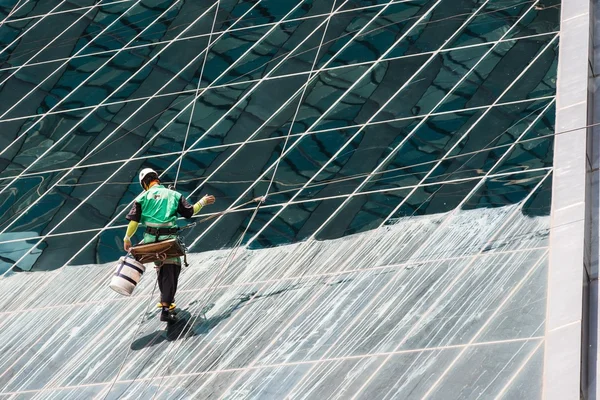 Window cleaners cleaning a high rise office building
