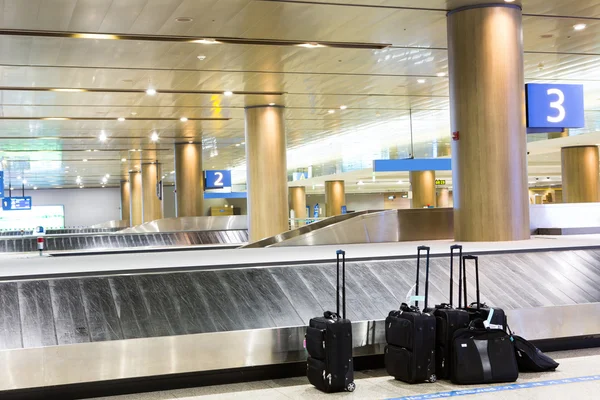 Suitcases at airport interior at baggage claim