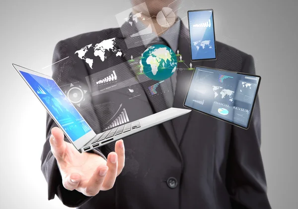 Businessman with laptop,mobile phone,touch screen device