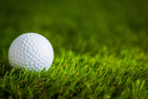 Golf ball on green grass