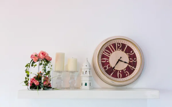 Wall decorated with clocks ,flower and candle