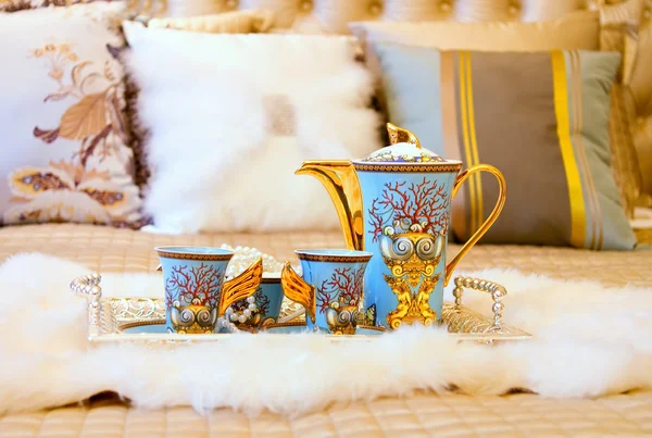 Closeup photo of Chinese beverage suite on wedding bed to celebr
