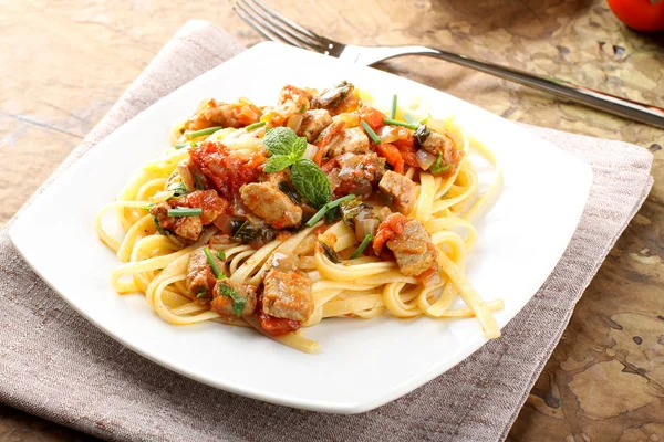 Pasta with chunks of fresh tuna, tomato and mint