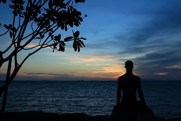 Silhouette of yoga male in lotus pose