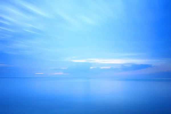 Long exposure seascape dramatic tropical sunset sky and sea at dusk
