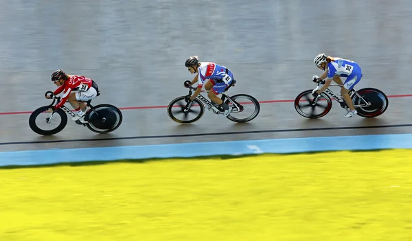 Three track cyclists