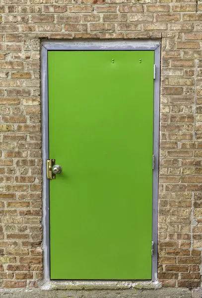 Green door on brick wall