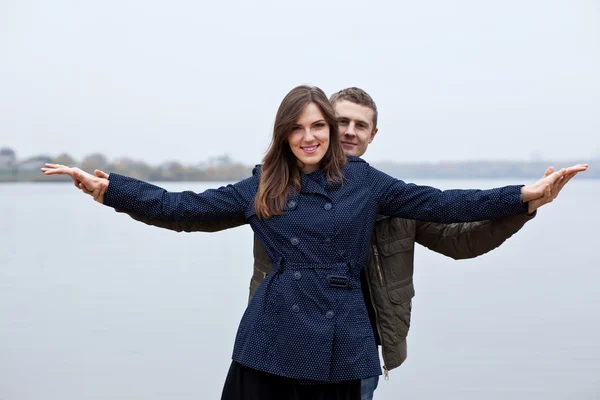 Young man and woman at shore lake