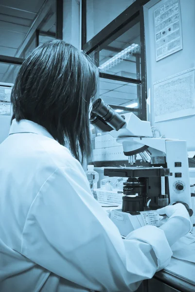 Serious clinician studying chemical element in laboratory — Stock Photo #30087839