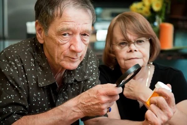 Senior couple examining medications