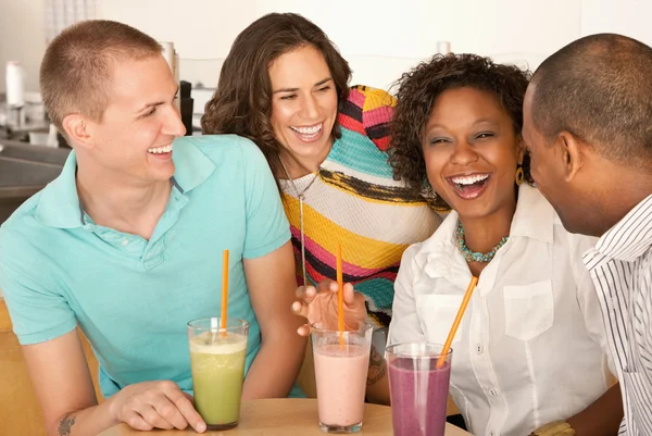 Two couples at a cafe drinking frozen beverages