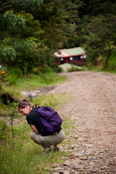 Hiker along side a rugged road in Costa Rica
