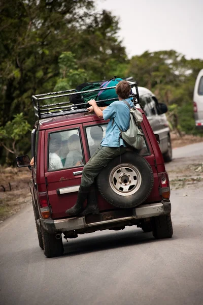 Man riding on the back of a van near Monteverde Costa Rica